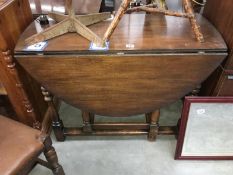 An oak gateleg table with turned legs