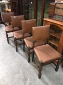 A 1930s set of 4 oak dining chairs with leather backs and seats