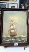 A framed oil on canvas of a ship in full sail, signed but indistinct