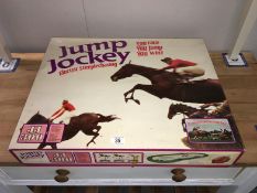 A boxed jump jockey electric steeple chase game