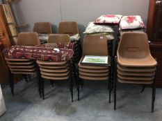 A large quantity of stacking chairs