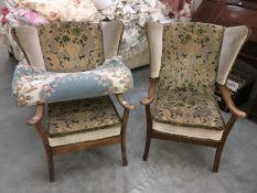 A matching pair of wing armchairs