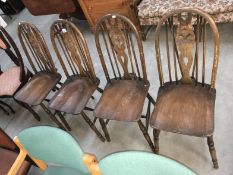A set of 4 wheel back chairs