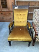 An early 20th century oak grandfather chair with gold draylon covering