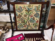 An oak framed tapestry fire screen