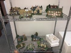 A collection of Thomas Kinkade Hawthorne Village Cottages and accessories