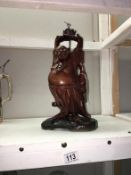 A carved wood Buddha table lamp base