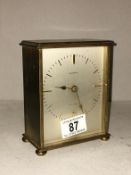 A heavy Swiss brass clock by Garrard (in working order)