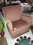 A pink upholstered childs chair