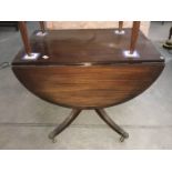 A drop leaf mahogany tea table