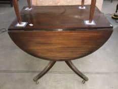 A drop leaf mahogany tea table