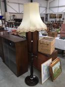 A drak wood stained standard lamp