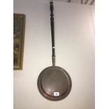 A copper Victorian warming pan