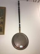 A copper Victorian warming pan
