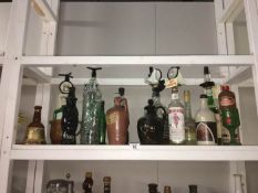 A quantity of assorted alcohol bottles some with contents