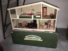 A boxed 1970s Claremont Chalet dolls house and contents