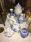 A quantity of oriental blue and white items including teapots,