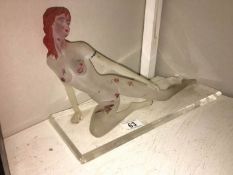 An acryllic nude figurine