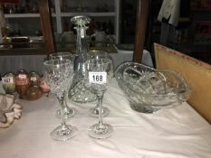 A cut glass decanter and 4 glasses and a bowl