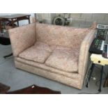 A pink upholstered drop end settee