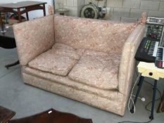 A pink upholstered drop end settee