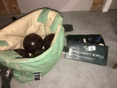 A set of 4 lawn bowls and a set of carpet bowls