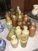 A quantity of stoneware beer bottles some named