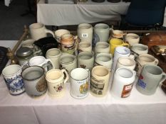 A large quantity of stoneware tankards and steins including military