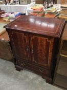 An inlaid mahogany two drawer cabinet