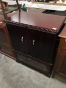 A dark wood stained TV cabinet