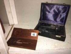 A cased smoking set and cased champagne thermometer