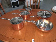A set of six Stellar copper saucepans