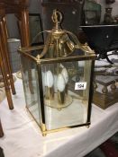 A brass five sided ceiling light with bevelled glass panels