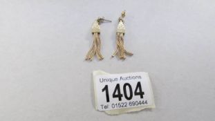 A pair of pendant earrings fashioned as tassels