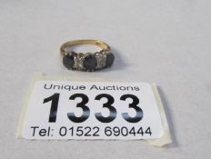 A 10k gold ring set 3 blue stones