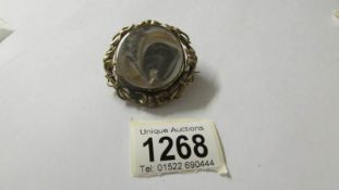 A Victorian swivel hair brooch with locket back