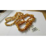 2 long strands of yellow amber beads