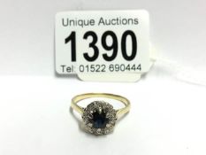 A vintage diamond and sapphire cluster ring set in 18ct gold,