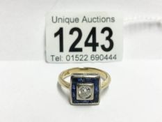 An 18ct yellow gold square shaped ring with centre 35pt diamond surrounded by sapphires,