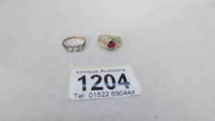 2 9ct yellow gold dress rings, one being 3 stone and one heart shaped,