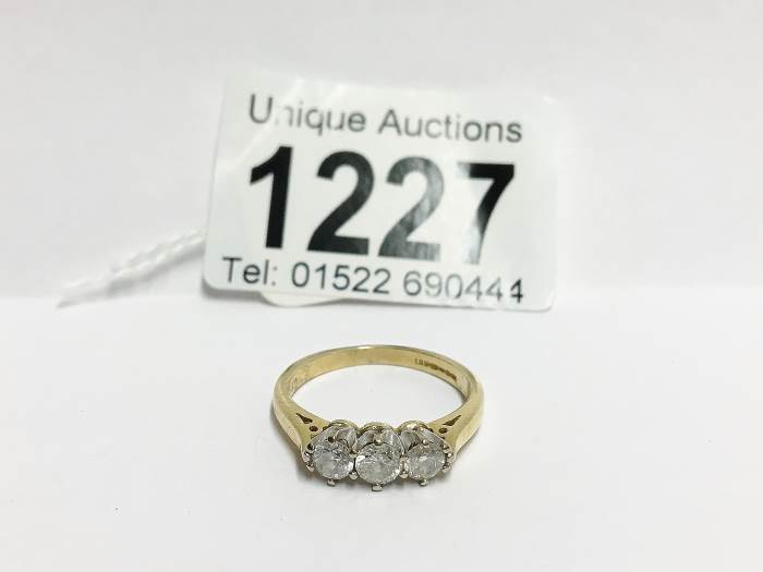 A 3 stone yellow gold half carat diamond ring,
