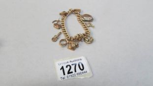 A gold charm bracelet with charms
