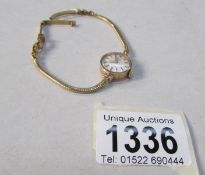 A 9ct gold ladies Rotary 21 jewel wrist watch on 18ct gold bracelet