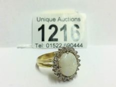 An 18ct white gold oval opal and diamond ring,