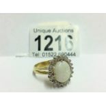 An 18ct white gold oval opal and diamond ring,