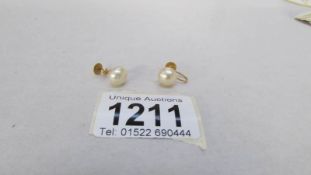 A pair of yellow gold screw pearl earrings