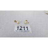 A pair of yellow gold screw pearl earrings