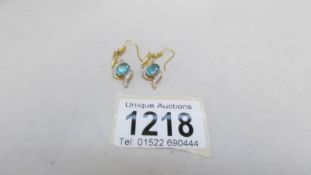 A pair of yellow metal topaz and diamond earrings