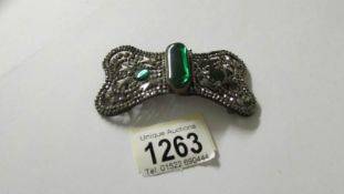 A Victorian cut steel buckle set with 3 green stones