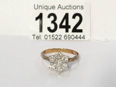 A ladies 18ct yellow and white gold 7 stone diamond cluster ring (total diamond weight 1.